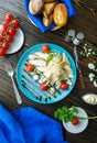 Caesar salad with croutons, quail eggs, cherry tomatoes and grilled chicken in wooden plate on dark rustic table Royalty Free Stock Photo