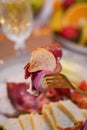 Caesar salad with croutons, quail eggs, cherry tomatoes and grilled chicken in wooden plate on dark rustic table Royalty Free Stock Photo