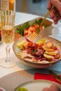 Caesar salad with croutons, quail eggs, cherry tomatoes and grilled chicken in wooden plate on dark rustic table Royalty Free Stock Photo