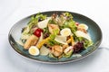 Caesar Salad. Delicious salad with croutons, fried chicken breast, grated Parmesan cheese and lettuce, with sauce in a gravy boat Royalty Free Stock Photo