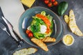 Caesar salad with egg, salmon, avocado, tomatoes and grilled toast on grey background. Paper menu with copy space. Flat lay, Top v Royalty Free Stock Photo