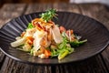 Caesar salad with fresh vegetables and crispy chicken on wooden background Royalty Free Stock Photo