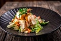 Caesar salad with fresh vegetables and crispy chicken on wooden background Royalty Free Stock Photo