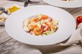 Caesar salad with fried shrimp, quail eggs and parmesan cheese on a white plate. Mediterranean Kitchen. Close-up Royalty Free Stock Photo