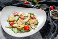 Caesar salad with grilled chicken, croutons, quail eggs and cherry tomatoes. White background. Top view Royalty Free Stock Photo