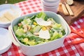 caesar salad packed for a picnic with plastic utensils