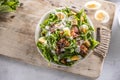 Caesar salad prepared from romaine lettuce, baked bacon, egg, bread croutons, garlic dressing and grated Parmesan cheese. Royalty Free Stock Photo