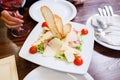 Caesar salad served on white plate in restaurant Royalty Free Stock Photo