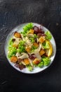 Caesar salad, shot from the top on a black background Royalty Free Stock Photo