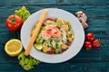 Caesar salad with shrimp. On a blue wooden background. Royalty Free Stock Photo