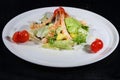 Caesar salad with shrimps on a white plate Royalty Free Stock Photo