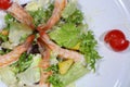 Caesar salad with shrimps on a white plate Royalty Free Stock Photo