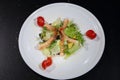 Caesar salad with shrimps on a white plate Royalty Free Stock Photo