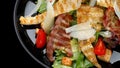 Caesar salad with crispy bacon, grilled chicken, and Parmesan cheese Royalty Free Stock Photo