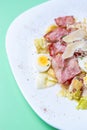 Caesar salad wtih quail,chicken,bacon and parmesan cheese served on white plate in restaurant for breakfast meal.Delicious Italian Royalty Free Stock Photo