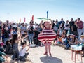 A participant of the Purim festival dressed in fabulous costume, shows a show with soap bubbles in Caesarea, Israel