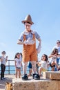 A participant of the Purim festival dressed in Pinocchio costume participates in the show in Caesarea, Israel