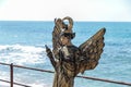 A participant of the Purim festival stands dressed in a fairy statue costume in Caesarea, Israel