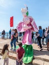A participant of the Purim festival stands dressed in a fairy statue costume in Caesarea, Israel