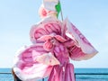 A participant of the Purim festival stands dressed in a fairy statue costume in Caesarea, Israel
