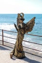 A participant of the Purim festival stands dressed in a fairy statue costume in Caesarea, Israel