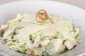 Caeser Salad with chicken fillet, white plate, brown background