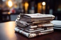 Cafe ambiance newspapers neatly stacked on a table for perusal Royalty Free Stock Photo