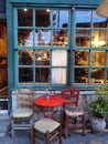 Cafe bar windows door table chairs in the evening in ioannina city greece