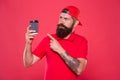 Cafe barista hold coffee cup. Coffee to go. Cafe stuff red uniform with cap serving drink. Hot beverage. Hipster work at Royalty Free Stock Photo