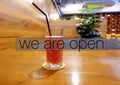 Cafe interior with We are open text overlay