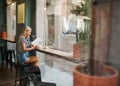 Cafe city lifestyle woman sitting in trendy urban cafe reading m