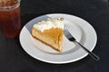 Cafe dessert scene with plated pumpkin cheesecake, fork, iced te