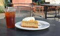 Cafe dessert scene with plated pumpkin cheesecake, fork, iced te