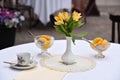 Cafe, flowers and peaches. yellow lilies Royalty Free Stock Photo