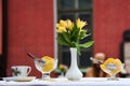 Cafe, flowers and peaches. yellow lilies Royalty Free Stock Photo