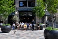 Cafe guests enjoy cold glass ans sun shin in outdoor cafe