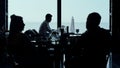 Cafe guests silhouettes resting panoramic lounge bar looking scenic seascape