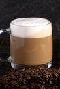 Cafe Latte Coffee in a Clear Glass Mug in a Dark Environment Royalty Free Stock Photo