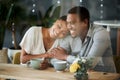 Cafe, love and happy black couple on a date hugging, talking or holding hands while drinking coffee or tea. Happiness Royalty Free Stock Photo