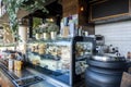 Cafe open bar counter area, showcasing a cabinet containing a variety of pre-made sandwiches