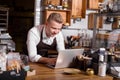 Cafe owner working on laptop