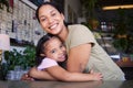 Cafe, portrait and mother hug kid in coffee shop for love, care or quality time together. Happy parent hugging girl Royalty Free Stock Photo