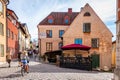 A cafe restaurant on cobblestone street with old ancient buildings in the city of Visby Gotland. Royalty Free Stock Photo
