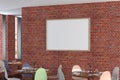 Cafe or restaurant intrerior with blank horizontal poster on the red brick wall. Royalty Free Stock Photo