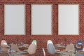 Cafe or restaurant intrerior with blank three vertical posters on the red brick wall. Royalty Free Stock Photo