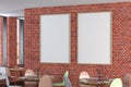 Cafe or restaurant intrerior with blank two vertical posters on the red brick wall. Royalty Free Stock Photo