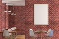 Cafe or restaurant intrerior with blank vertical poster on the red brick wall. Royalty Free Stock Photo