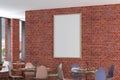 Cafe or restaurant intrerior with blank vertical poster on the red brick wall. Royalty Free Stock Photo