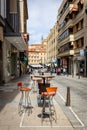 Cafe and restaurant table with chairs on a narrow medieval city street of Segovia, Spain.
