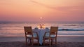 Cafe on the seaside, served table and two chairs on the seashore, romantic evening. Royalty Free Stock Photo